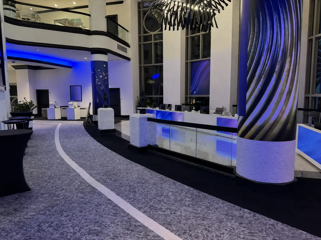 Unbranded hotel lobby and event registration area with managed internet and Wi-Fi connectivity