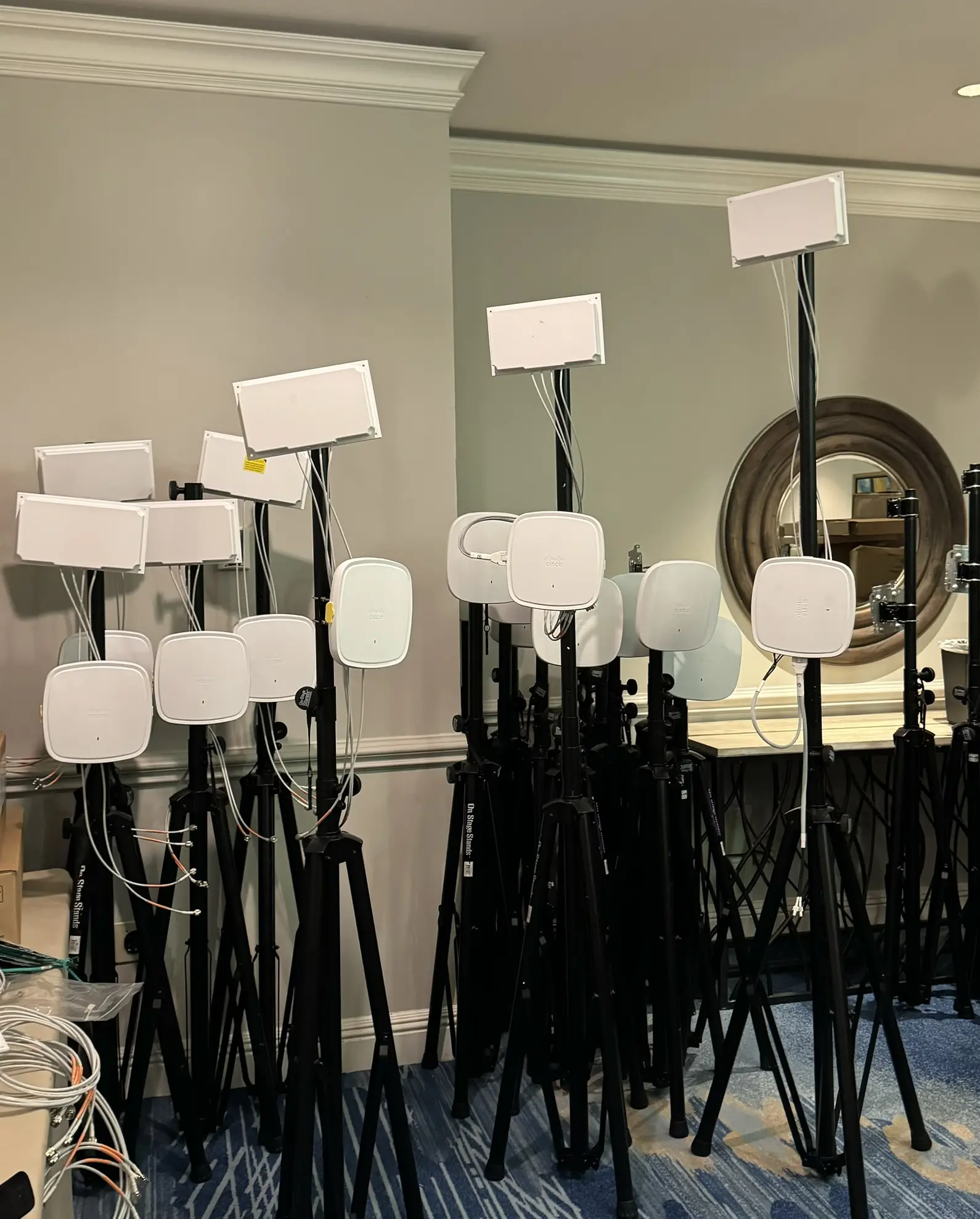 Wireless access points, mounting stands, and cabling staged for event Wi-Fi deployment